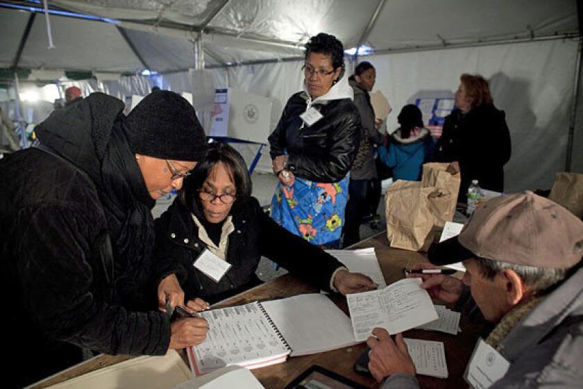 People vote in a tent in the Midland Beach neighborhood of Staten Island in New York City, hard hit by Superstorm Sandy last week.
