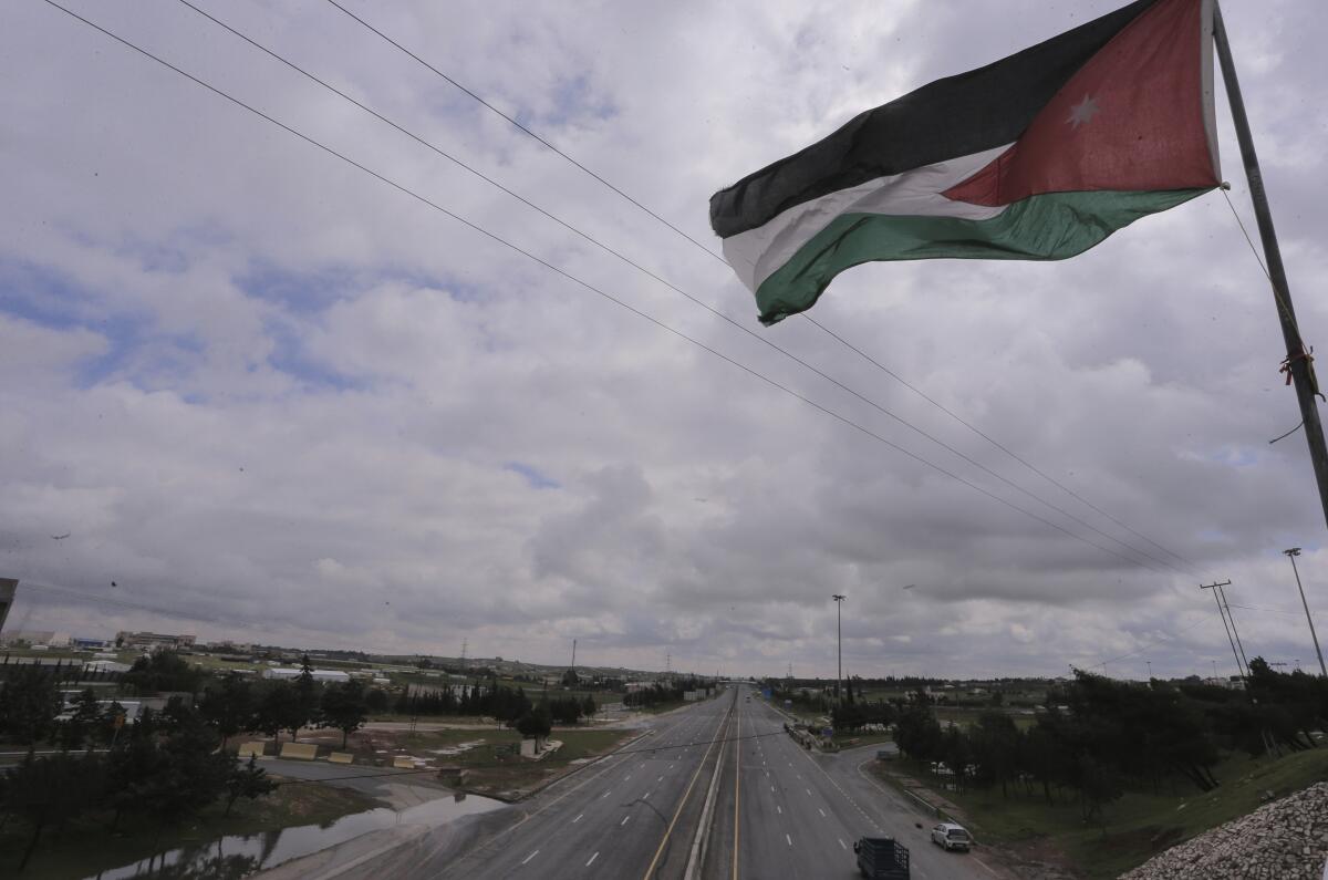 Jordan's flag flies over empty streets.