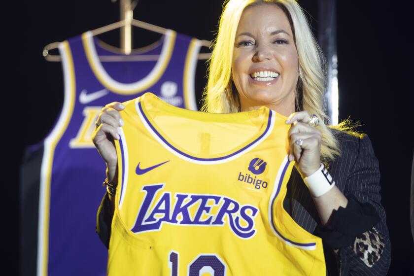 EL SEGUNDO, CA - September 20: Jeanie Buss, CEO / Governor / Co-owner of the Los Angeles Lakers, holds a new Lakers jersey as the Lakers host a 2021-2022 season kick-off event to unveil and announce a new global marketing partnership with Bibigo, which will appear on the Lakers' jersey at the UCLA Health Training Center in El Segundo on Monday, Sept. 20, 2021. (Allen J. Schaben / Los Angeles Times)