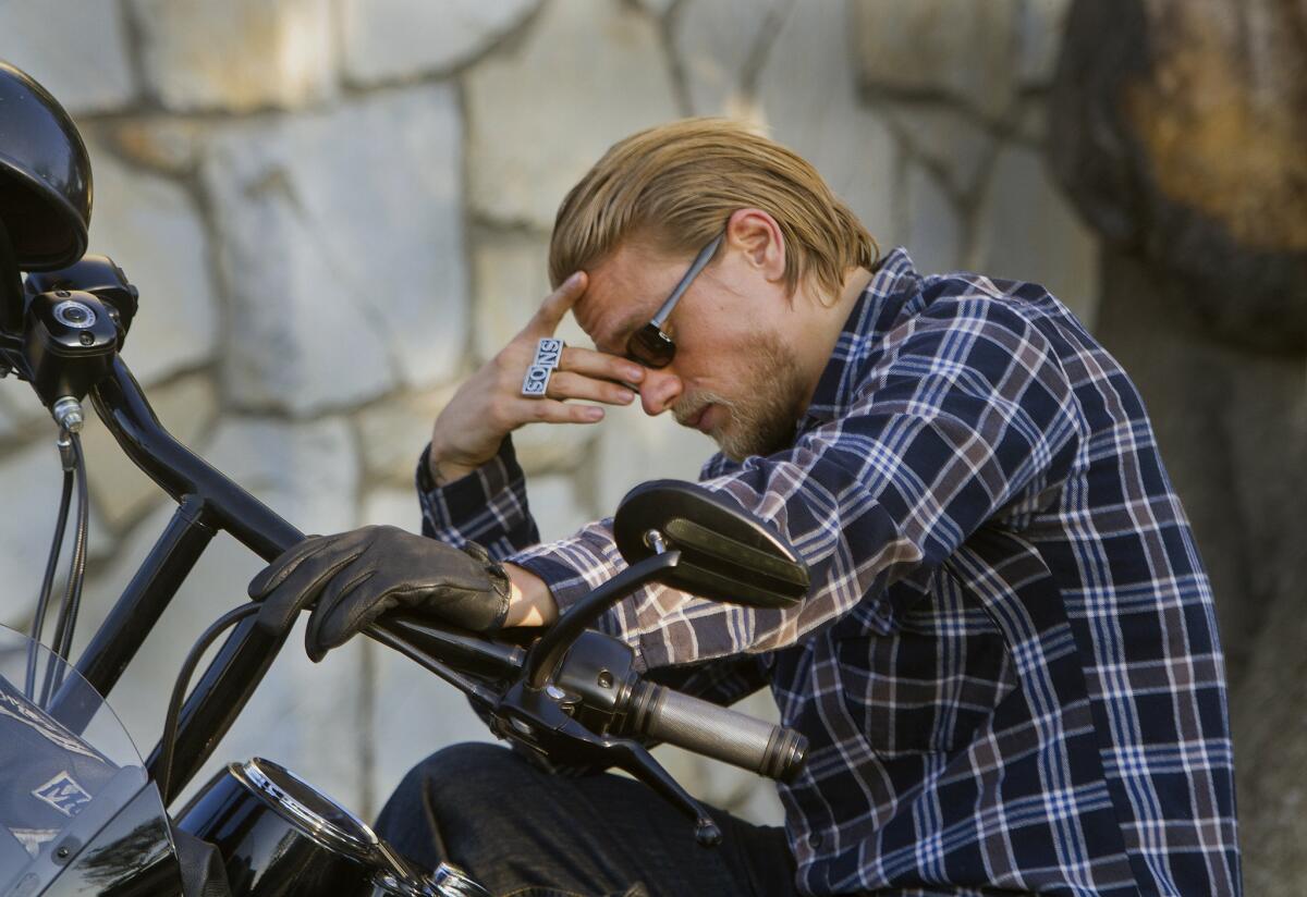 Charlie Hunnam of "Sons of Anarchy" sits on his motorcycle between takes while on location in North Hollywood.