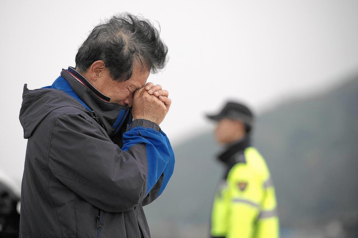 A relative weeps at an area where family members of victims of the South Korean ferry Sewol are gathered, at Jindo harbor on April 21, 2014.