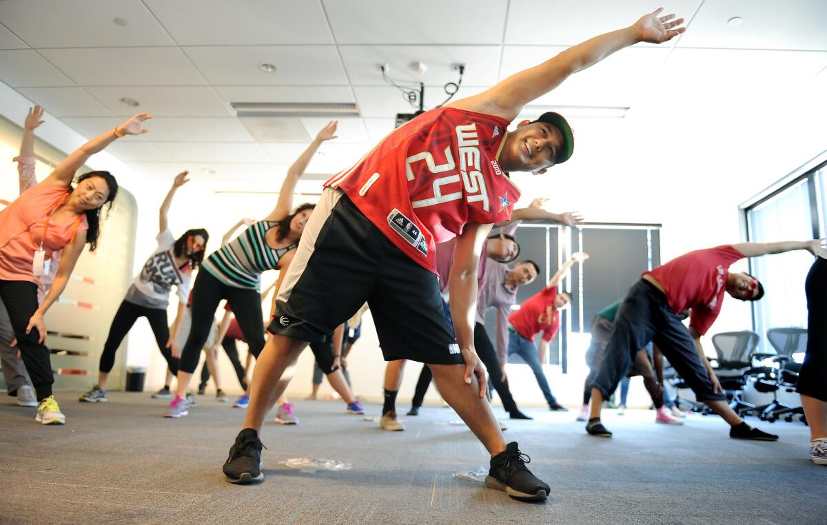 Limzer Lagrimas, center, teaches a hip hop dance class to fellow Edmunds.com employees during the company's "Summer Camp" in July 2015. (Christina House / For The Times)