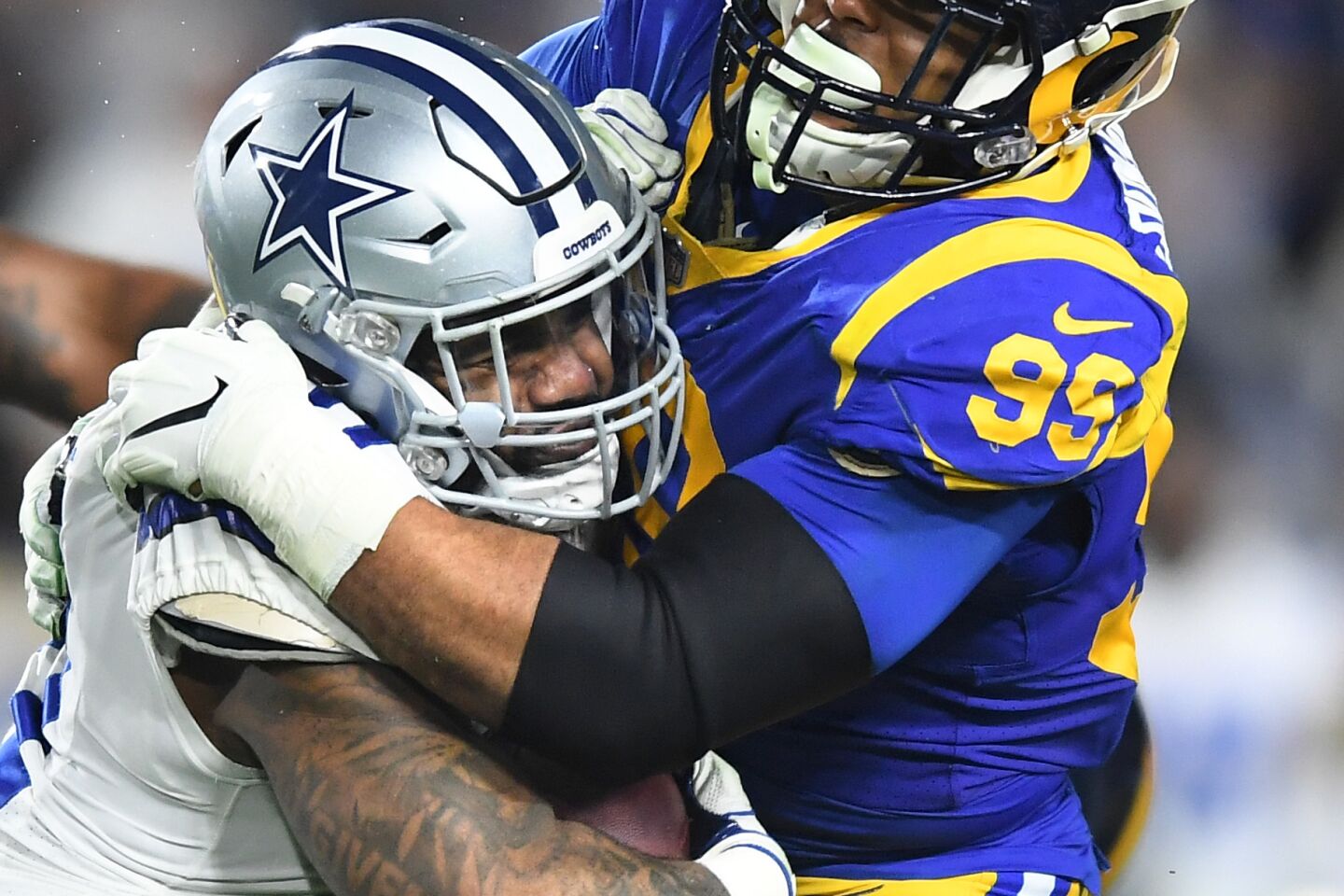 Rams defensive end Aaron Donald stops Cowboys running Ezekiel Elliott during a run in the third quarter.