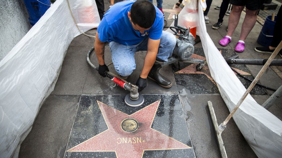 Vince Godinez, 34, of Los Angeles installs a star for 'N Sync.