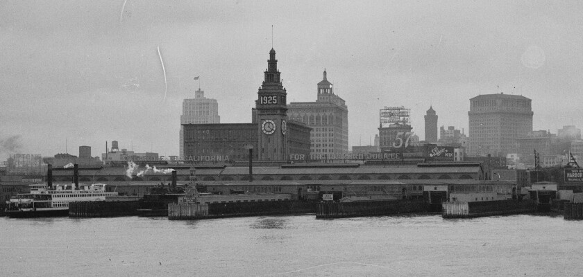 A city skyline is seen in the rear; in the foreground steamships are docked.