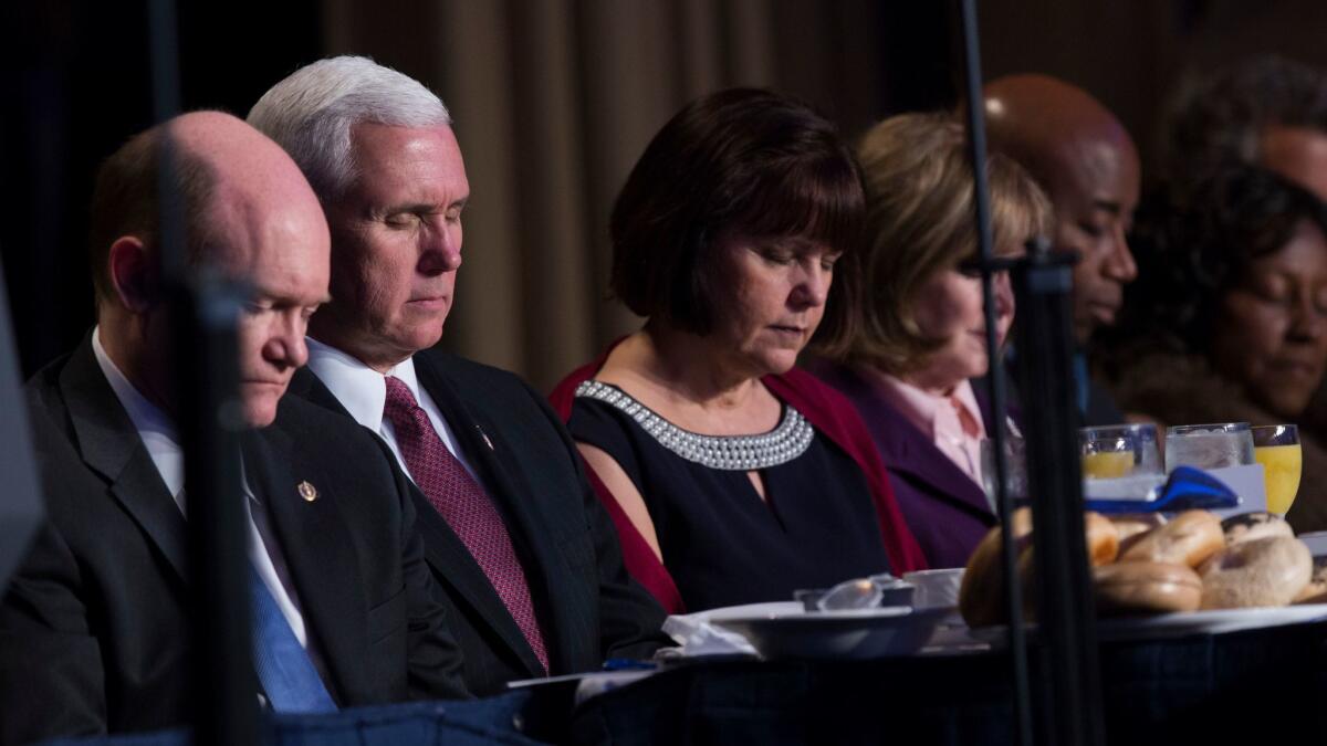 Vice President Mike Pence and his wife Karen pray during the National Prayer Breakfast on Feb 2 in Washington, where President Trump promised to “totally destroy” the Johnson Amendment.