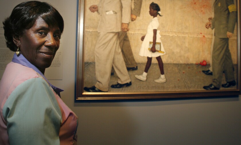 Lucille Bridges poses next to the original 1964 Norman Rockwell painting, "The Problem We All Live With"