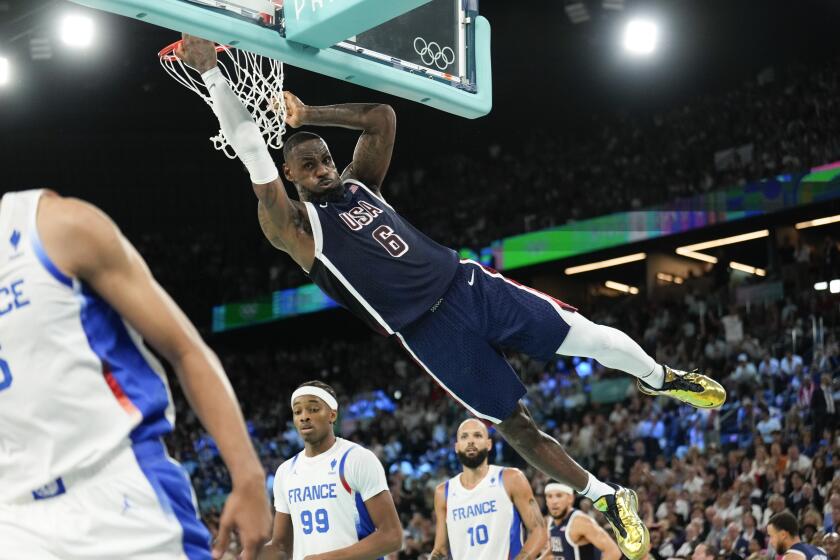 American LeBron James (6) dunks over France's Nicolas Batum (5) during a men's gold medal basketball game 