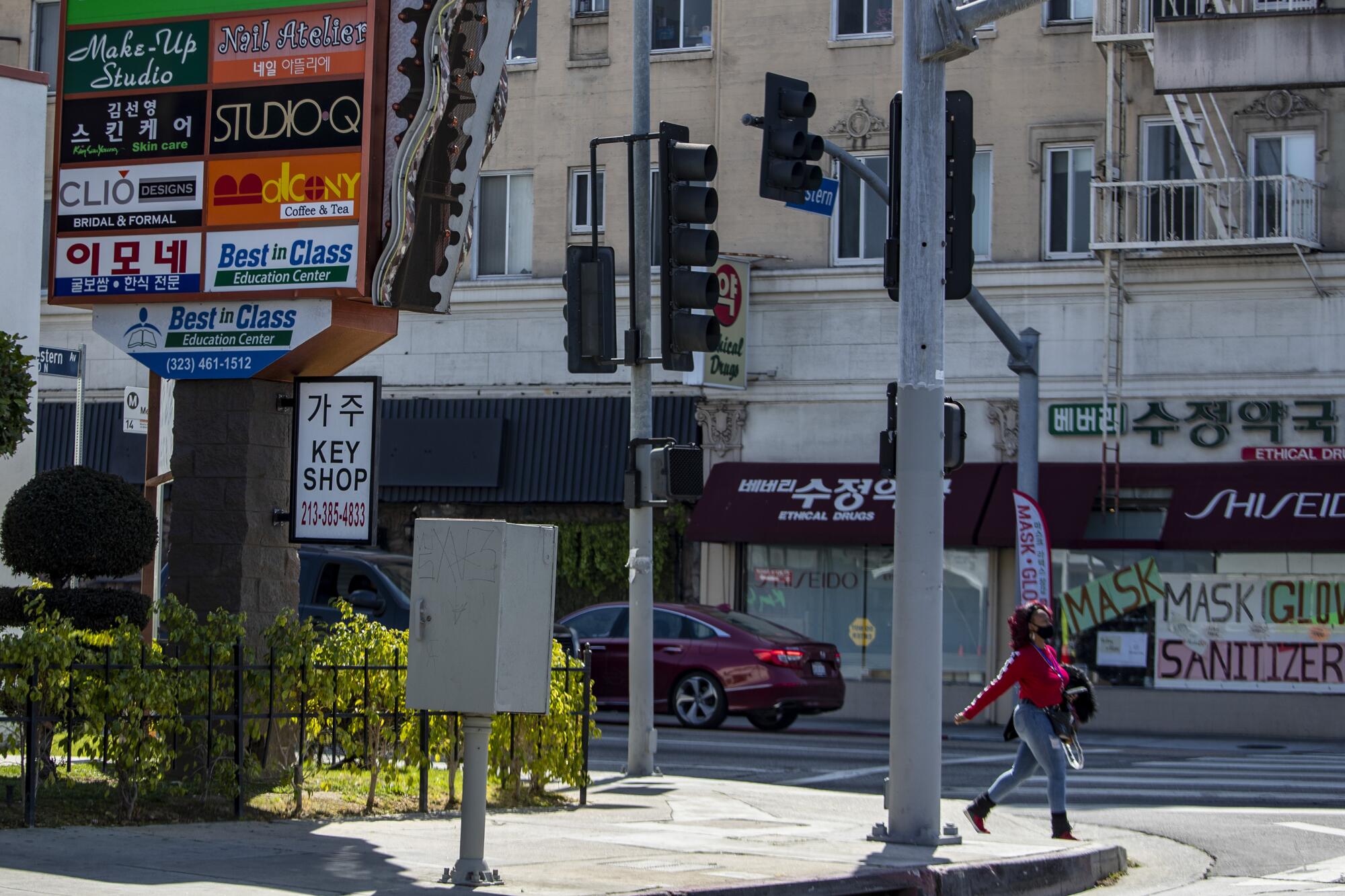 A street block in Koreatown with store fronts and signs