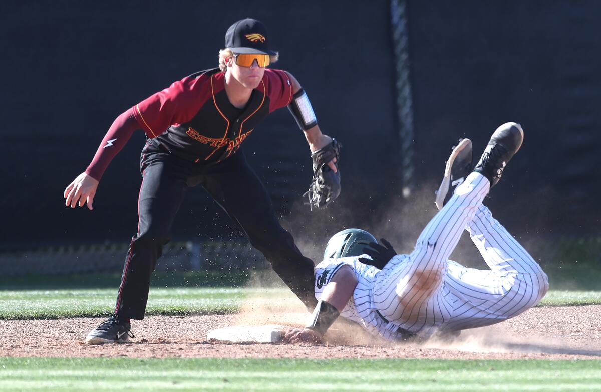 Estancia third baseman Cole Lefebvre tags out Costa Mesa's Grady Jackson during Friday's game.