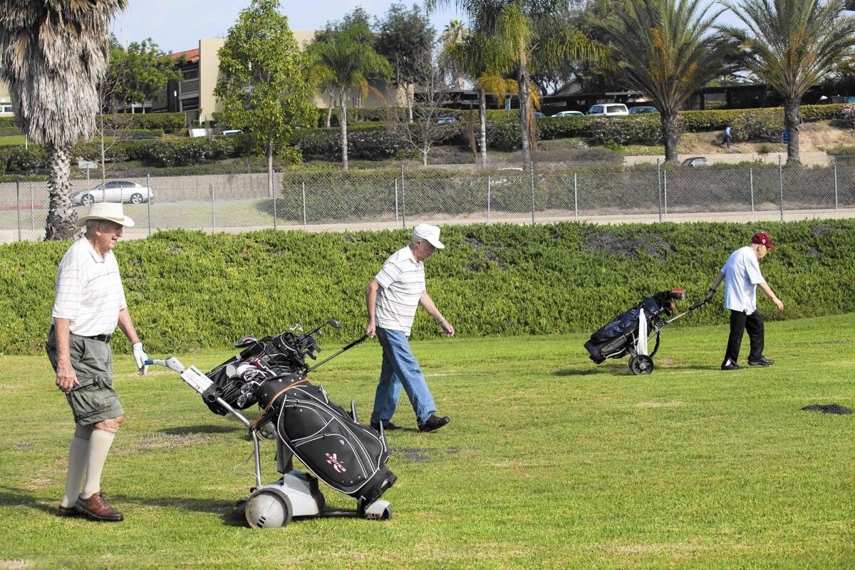 NEWPORT BEACH, SEPTEMBER 28, 2015 - Robert McKenzie, 87, left, Louie Donaher, 89, and Sam Stameson, 87, walk up the ninth hole at Newport Beach Golf Course on Monday, September 28. (Scott Smeltzer -Daily Pilot)