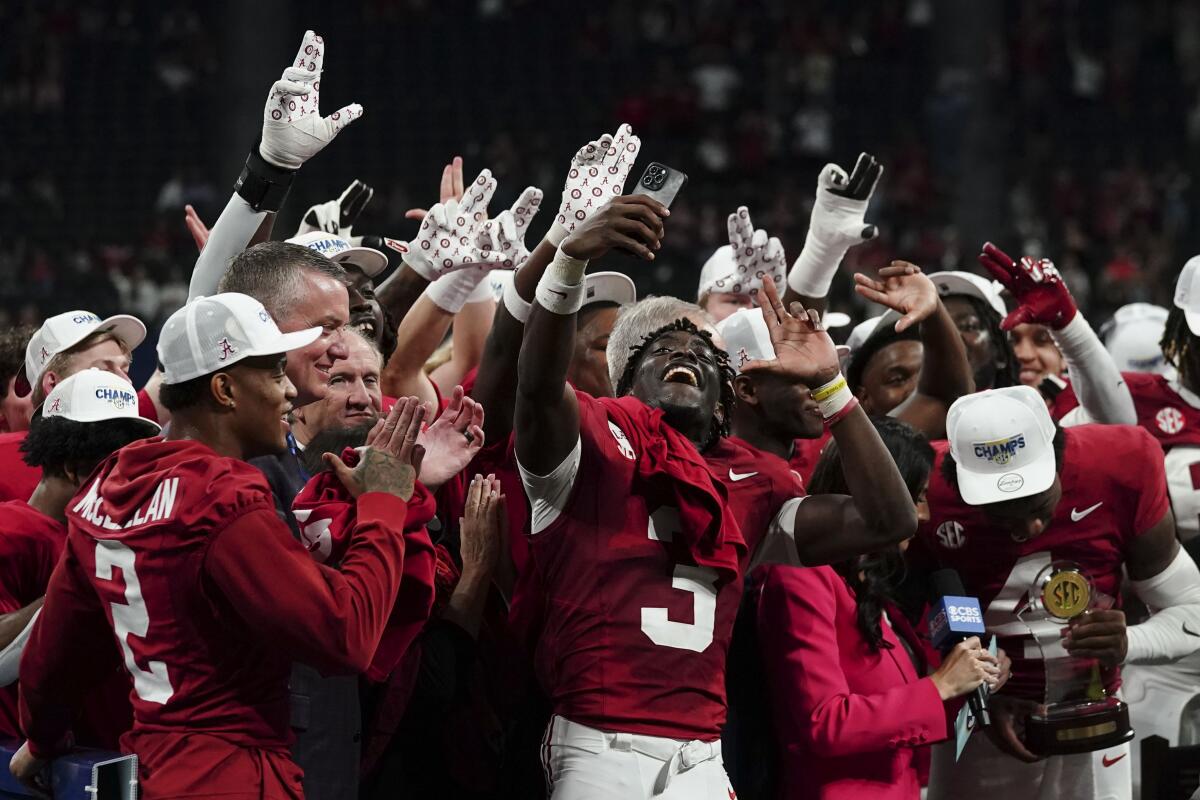 Alabama players celebrate after defeating top-ranked Georgia in the SEC championship game Saturday.