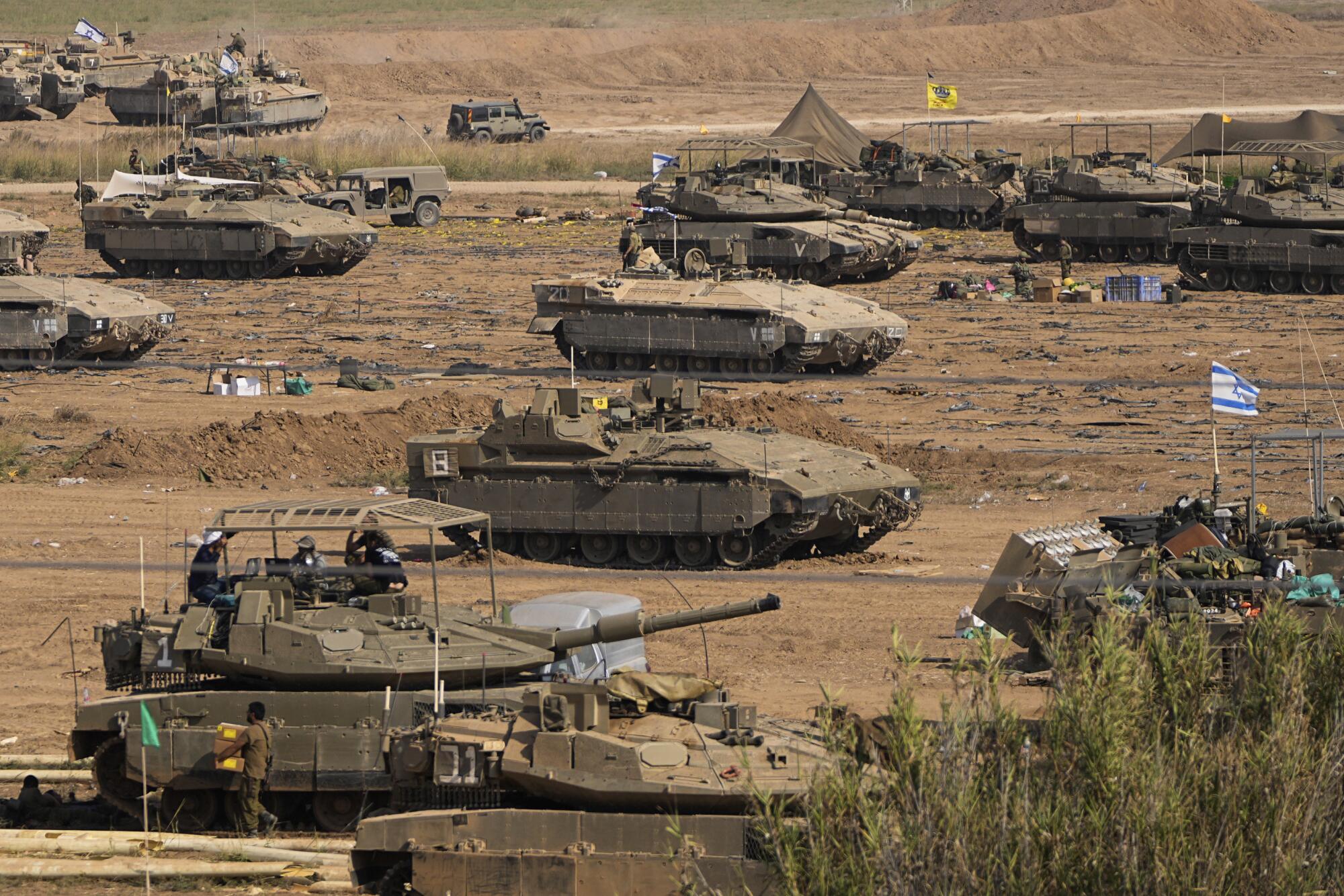 Israeli armored vehicles in a staging area near the border with Gaza