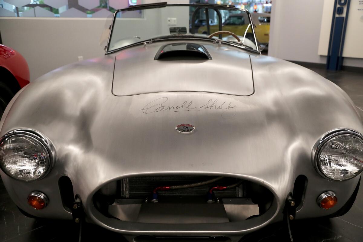 A 1965 AC/Shelby 427 Cobra Continuation CSX1002 with Carroll Shelby's signature on the front hood.