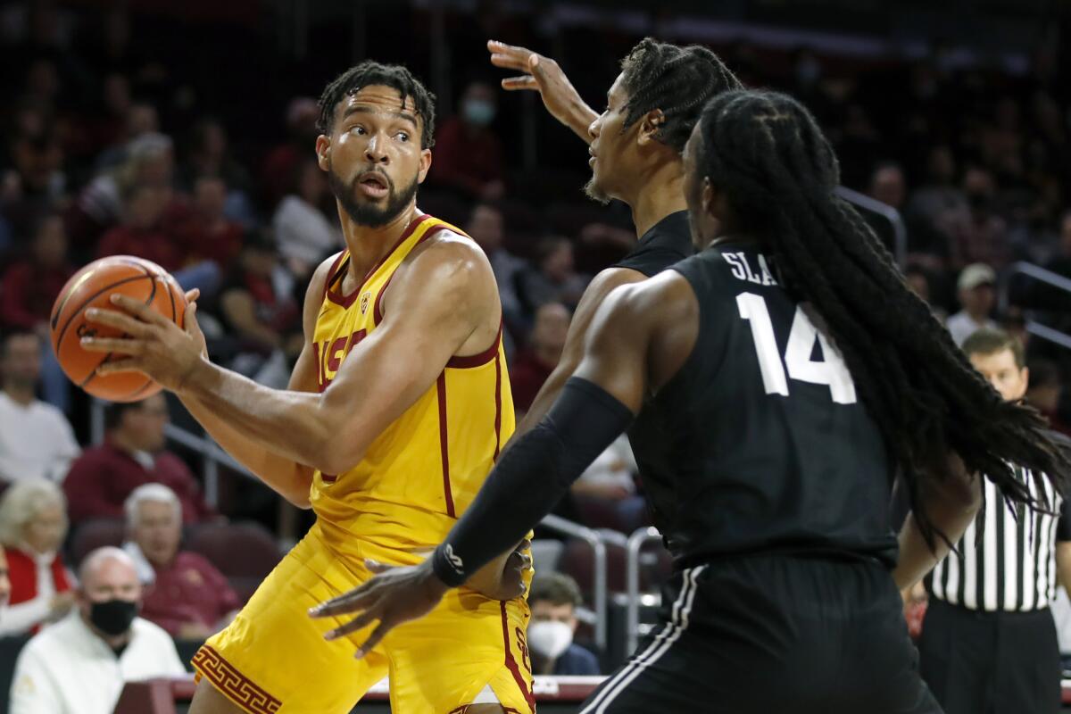 USC forward Isaiah Mobley looks to pass the ball against Long Beach State's Eddie Scott and Colin Slater.