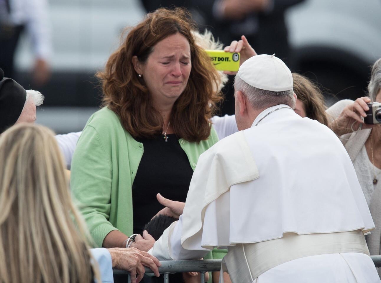 A woman cries as Pope Francis blesses her disabled son upon arrival in Philadelphia on Sept. 26, 2015, on the final leg of his six-day visit to the U.S.