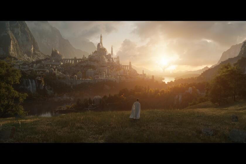 A lone figure in white looks down over a gleaming hilltop city at dusk.