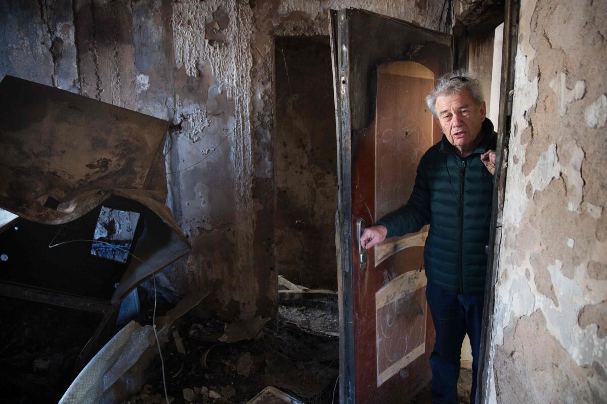 Israeli Aitan Shariel inspects the damage inside his house in the northern city of Haifa following a wildfire which authorities say was deliberately set.