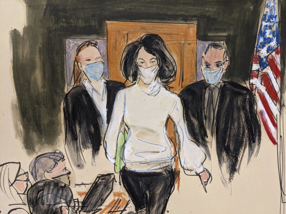 In this courtroom sketch, Ghislaine Maxwell enters the courtroom escorted by U.S. Marshalls at the start of her trial, Monday, Nov. 29, 2021, in New York. A late-June sentencing date was set Friday, Jan 14, 2022, for Maxwell following her conviction last month on charges including sex trafficking and conspiracy relating to the recruitment of teenage girls for financier Jeffrey Epstein to sexually abuse. (AP Photo/Elizabeth Williams, File)