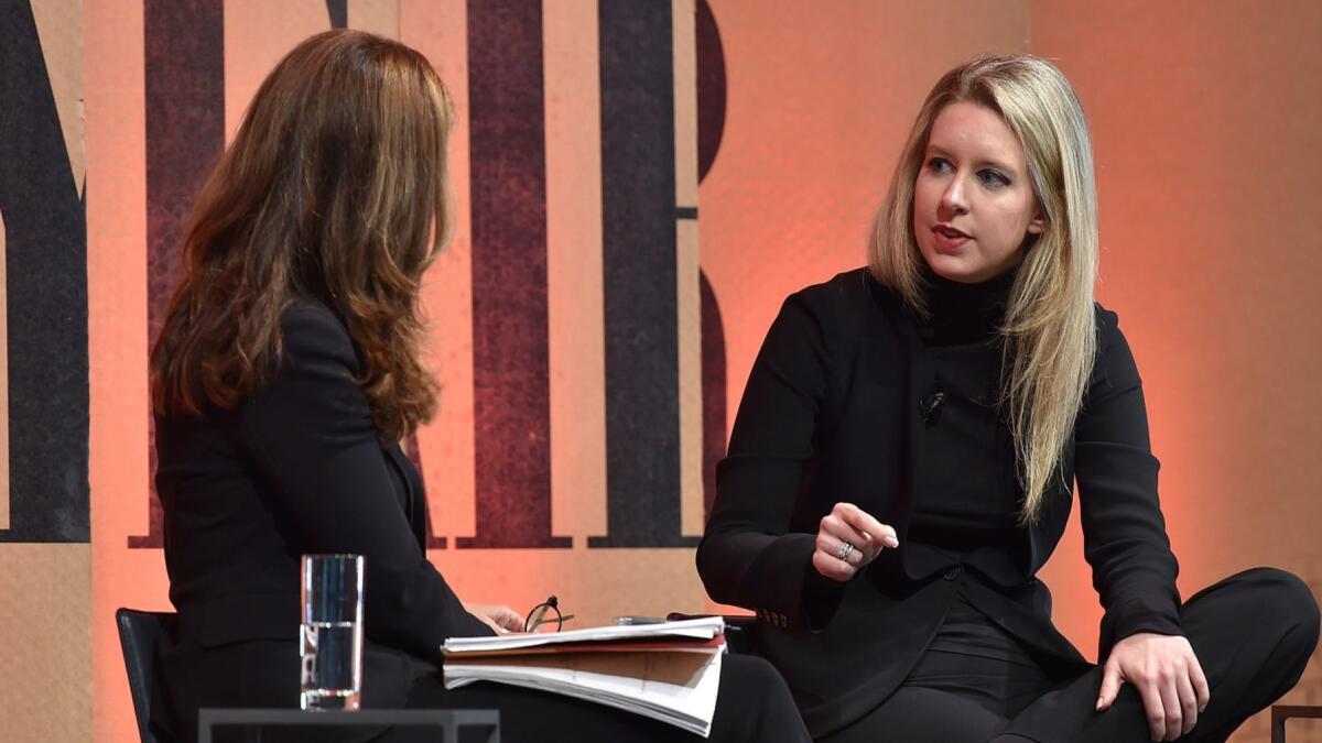 Happier times: Theranos founder Elizabeth Holmes (right) chats with Maria Shriver of NBC during a Vanity Fair magazine event in 2015.