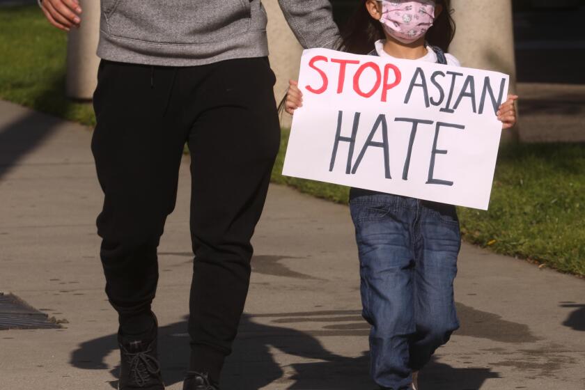 SAN GABRIEL, CA - MARCH 26, 2021 - - Summer Trinh, 5, joins around 200 residents, students and Alhambra and San Gabriel city leaders who participate in a march to denounce anti-Asian sentiment, racism and hate crimes that have been exacerbated by the COVID-19 pandemic in San Gabriel on March 26, 2021. The march started at San Gabriel City Hall and proceeded to Alhambra City Hall. (Genaro Molina / Los Angeles Times)