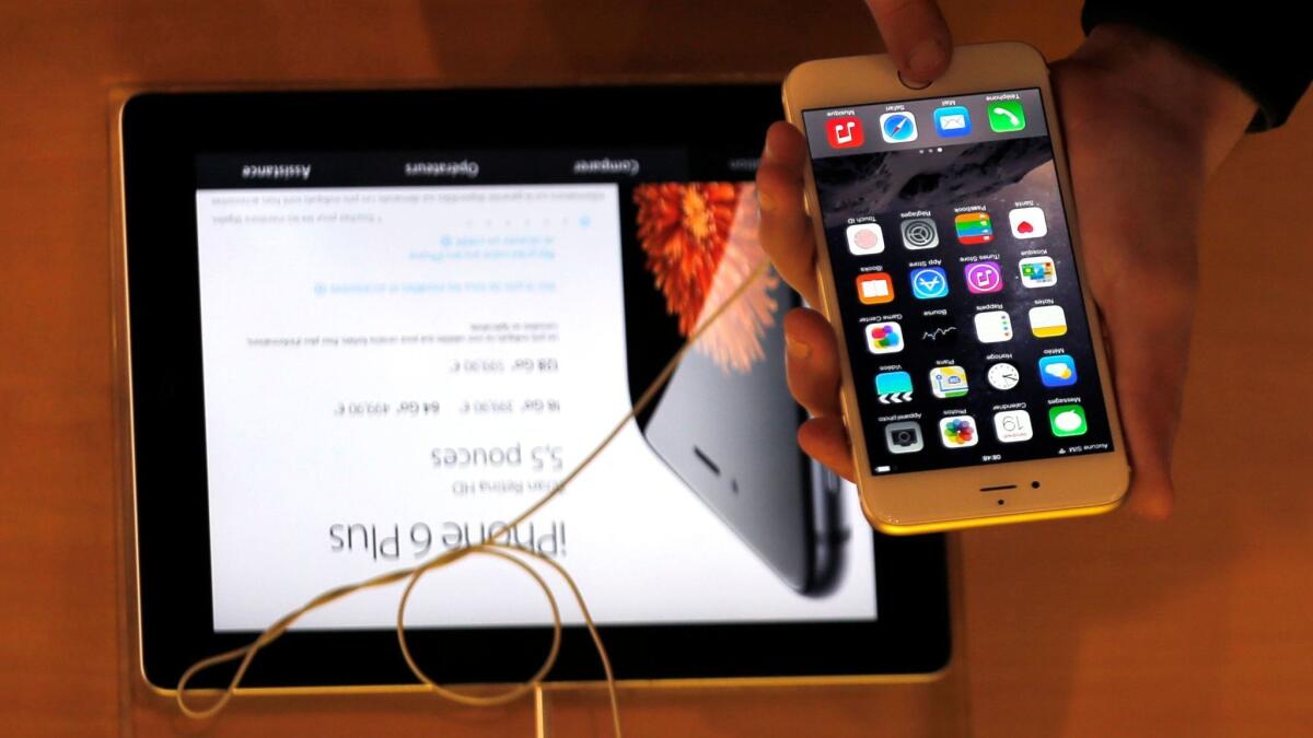 A person checks out an iPhone 6 in 2014.