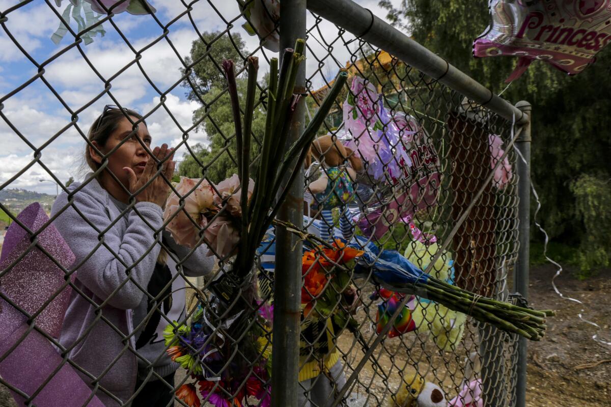 Sally Edwards, 50, from Pico Rivera, offers prayers on Thursday at a makeshift memorial for the dead girl.