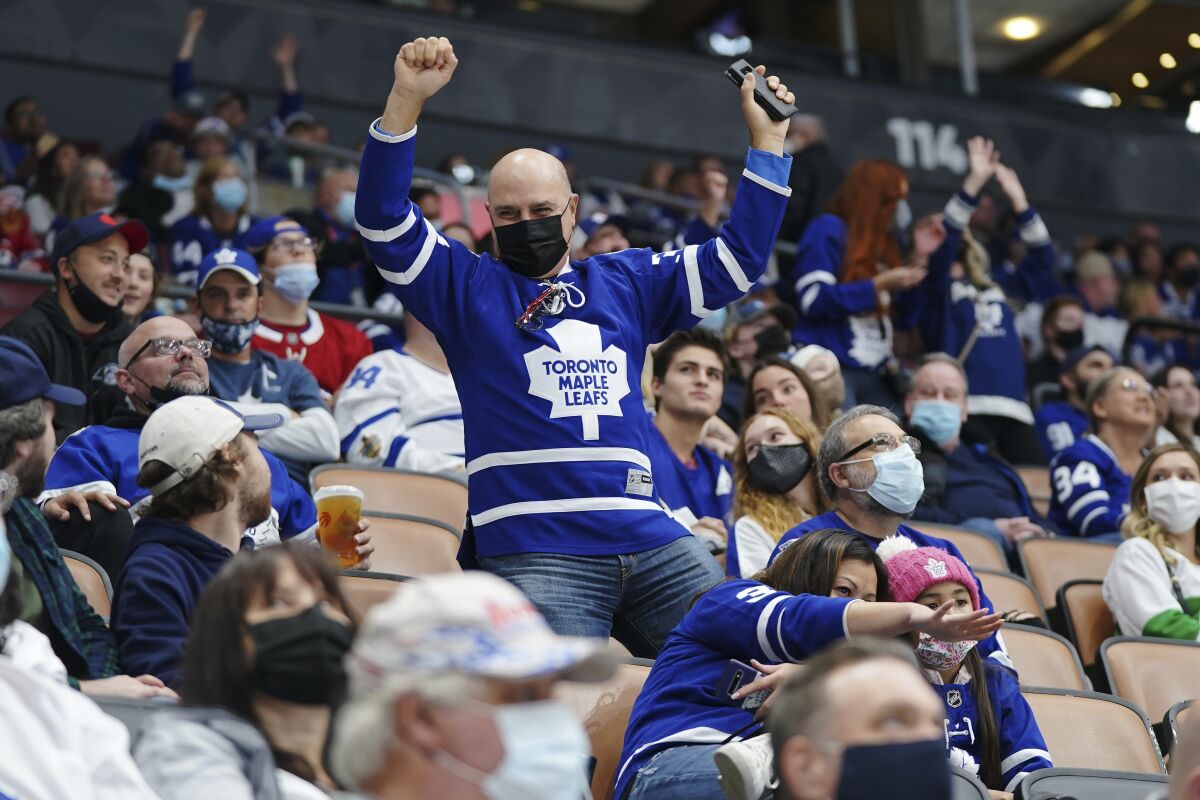 Fans dance during first period NHL pre-season hockey game between the Toronto Maple Leafs and Montreal Canadiens in Toronto. (Nathan Denette/The Canadian Press via AP)