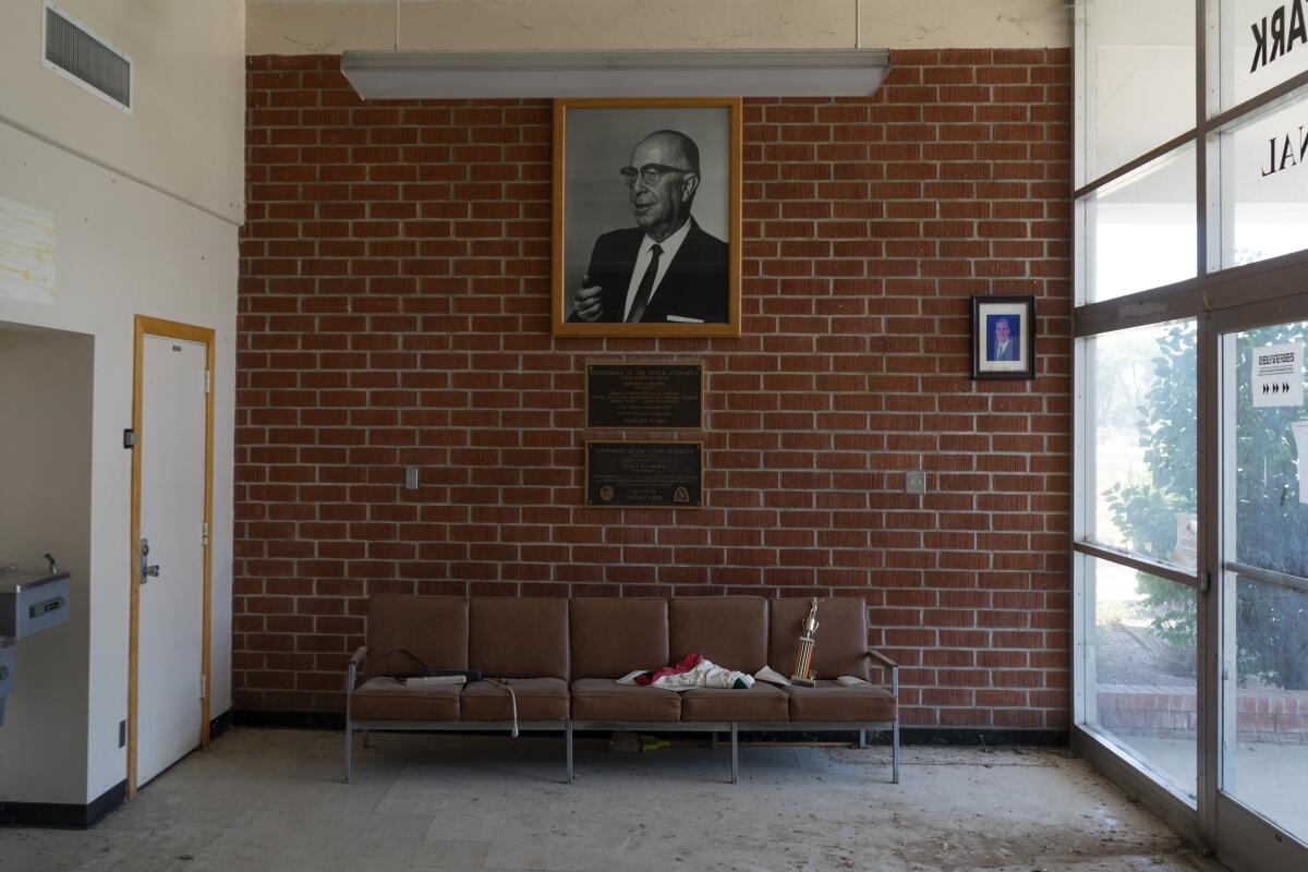 A  boxing trophy sits on a brown sofa inside defunct Youth Training School, a former youth prison in Chino.