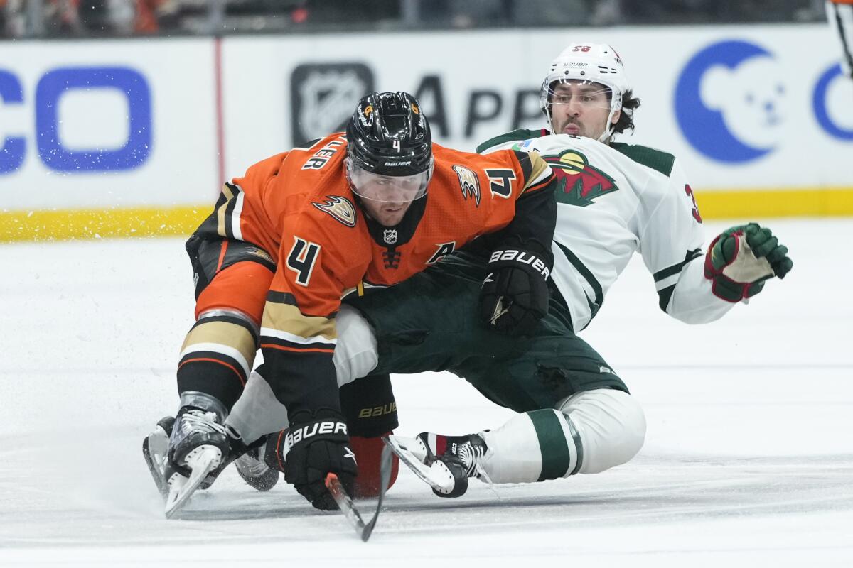 Anaheim Ducks' Cam Fowler, left, collides with Minnesota Wild's Mats Zuccarello during the first period of an NHL hockey game Wednesday, Nov. 9, 2022, in Anaheim, Calif. (AP Photo/Jae C. Hong)