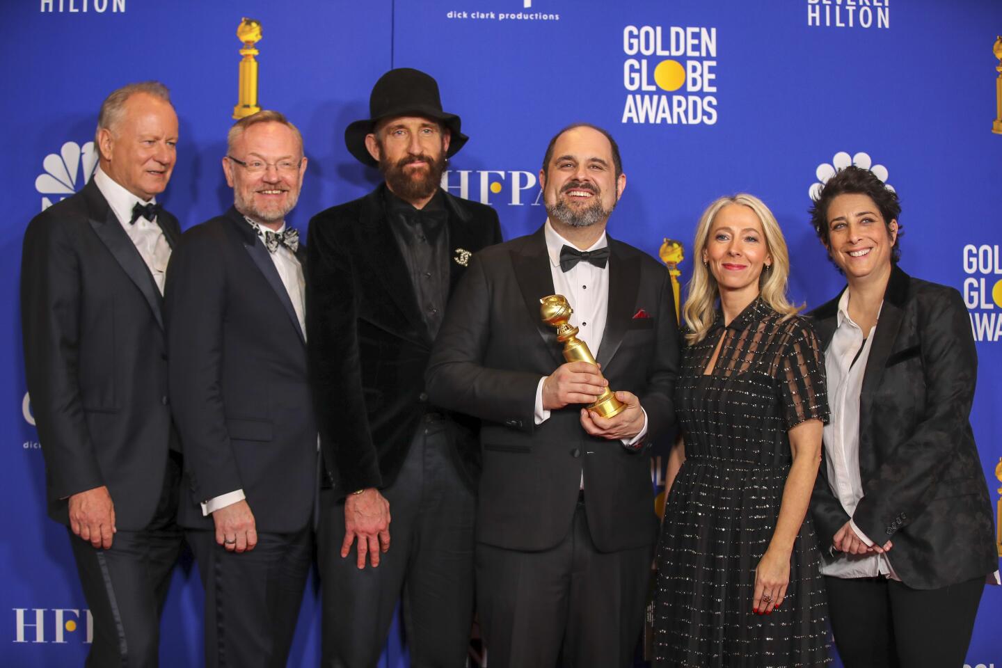 Stellan Skarsgård, Jared Harris, Johan Renck, Craig Mazin, Jane Featherstone, and Carolyn Strauss pose in the photo deadline room.