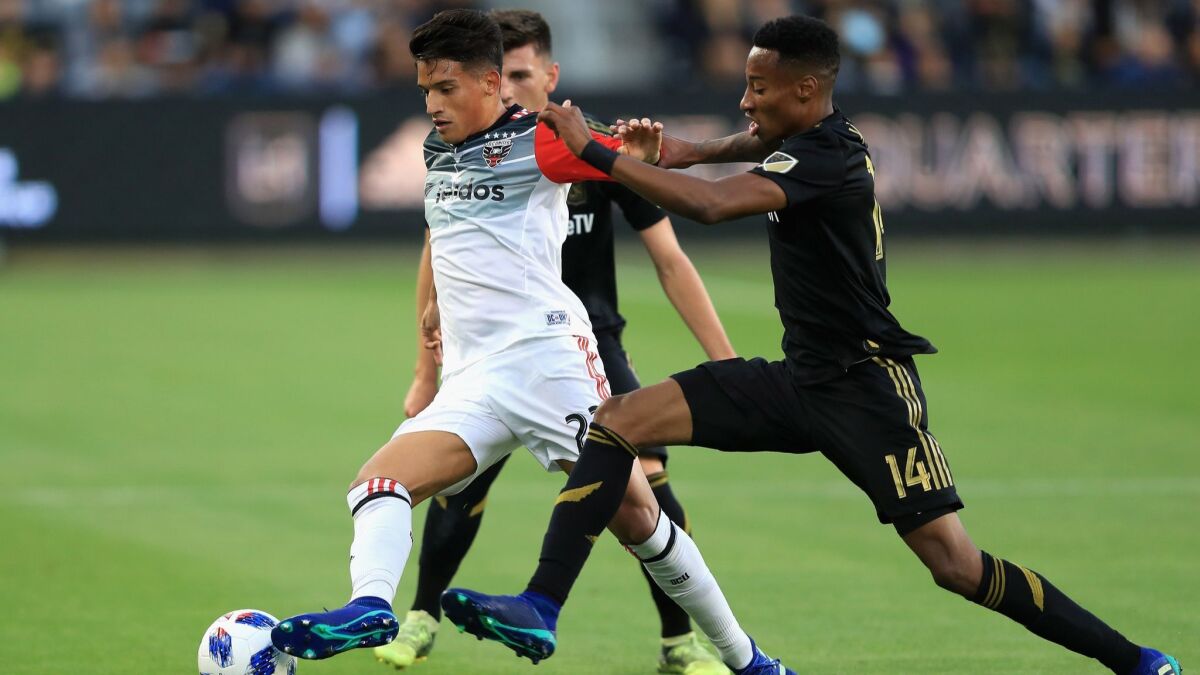 LAFC's Mark-Anthony Kaye, right, defends against D.C. United's Yamil Asad on May 26 at Banc of California Stadium.