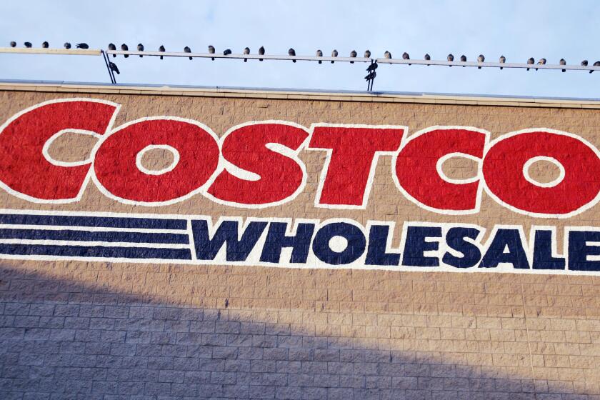 Birds are perched above a Costco store in Mountain View, Calif., Wednesday, Dec. 12, 2007. Costco Wholesale Corp. on Thursday, Dec. 13, 2007 said its fiscal first-quarter profit rose 11 percent as sales and membership fees both grew. The results were in line with Wall Street expectations, but its shares slid almost 5 percent in morning trading on disappointment at Costco's operating margins especially in its gasoline operations. (AP Photo/Paul Sakuma) ORG XMIT: CAPS137