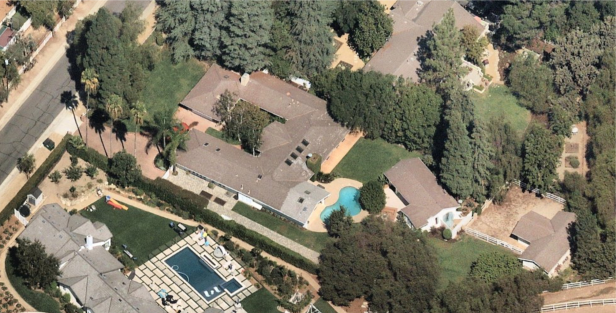 An aerial view of the equestrian compound , with main house,  guesthouse and swimming pool.