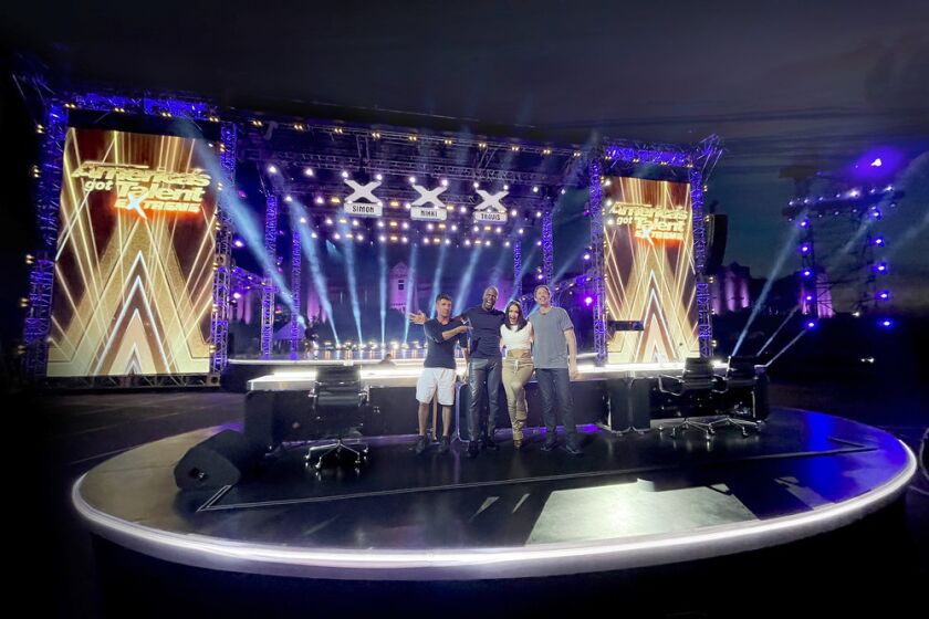 Four people on a TV talent show set