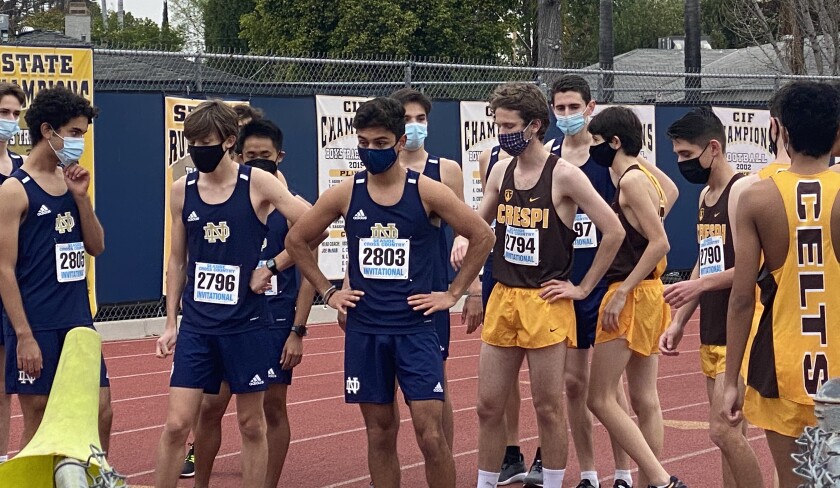 Masked runners from Crespi and Sherman Oaks Notre Dame on a track