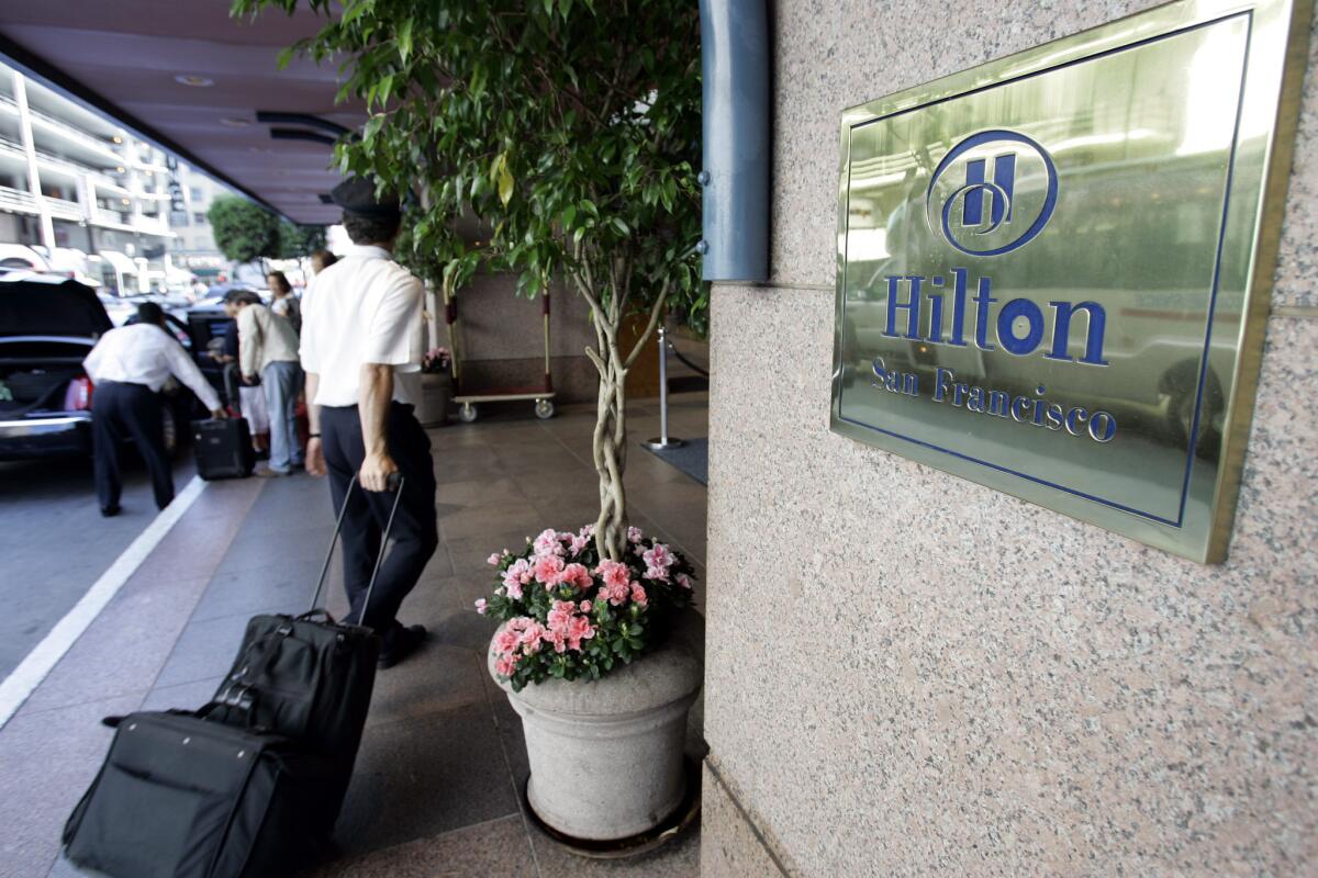 A guest walks into a Hilton Hotel in downtown San Francisco. Hilton Worldwide plans to give guests the ability to pick a room from a hotel floor plan.