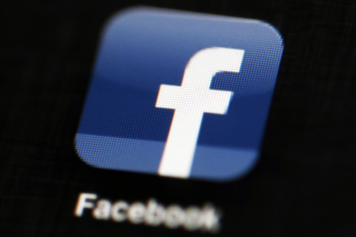 FILE - This May 16, 2012 file photo shows the Facebook app logo on a mobile device in Philadelphia. On Monday, Oct. 12, 2020, Facebook announced it is banning posts that deny or distort the Holocaust and will start directing people to authoritative sources if they search for information about the Nazi genocide. (AP Photo/Matt Rourke, File)