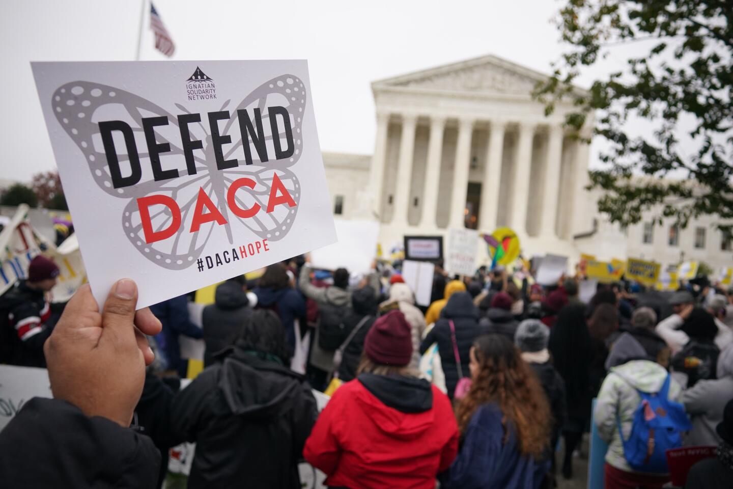 Immigration rights activists rally in front of the U.S. Supreme Court in Washington