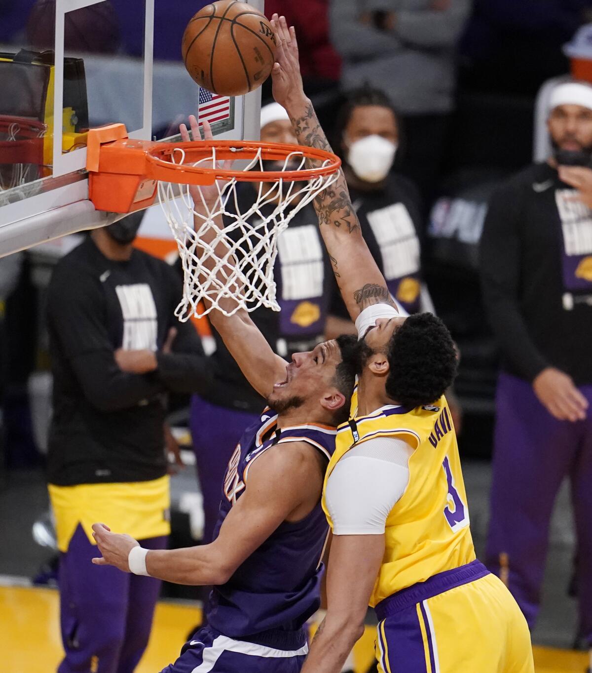 Lakers forward Anthony Davis blocks a shot by Suns guard Devin Booker during Game 3 on May 27, 2021, at Staples Center.
