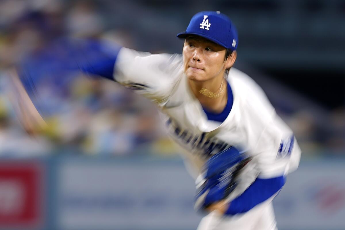 Yoshinobu Yamamoto throws to the plate during the first inning.