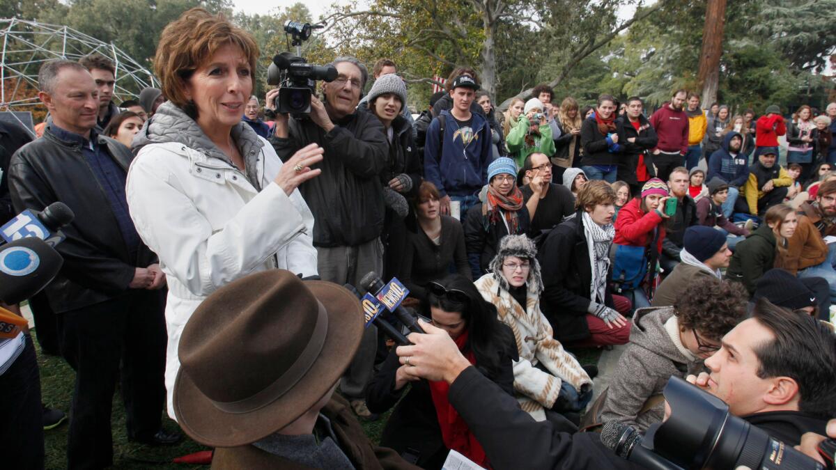 Linda Katehi, then the Chancellor of UC Davis, attempts to address students gathered at an Occupy UC Davis encampment in 2011.