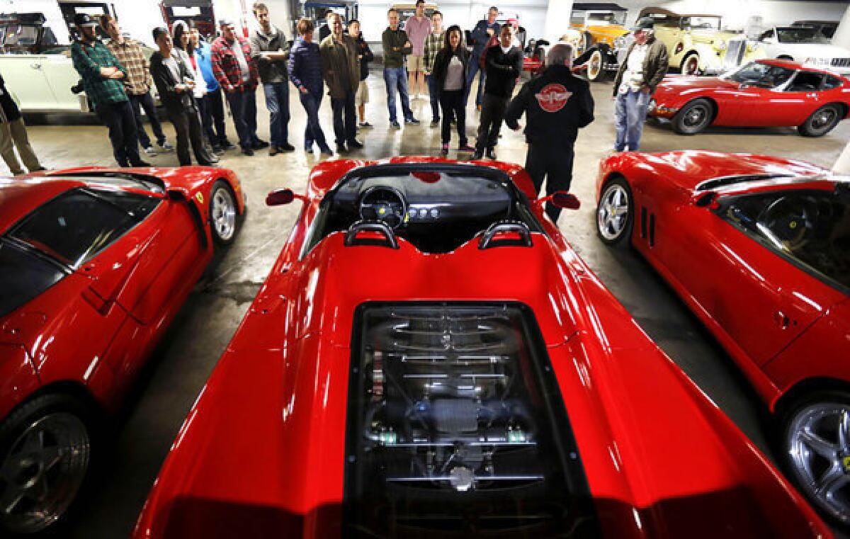 Tour guide Kevin Blackley talks about a trio of Ferraris to visitors touring the Petersen Automotive Museum vault.