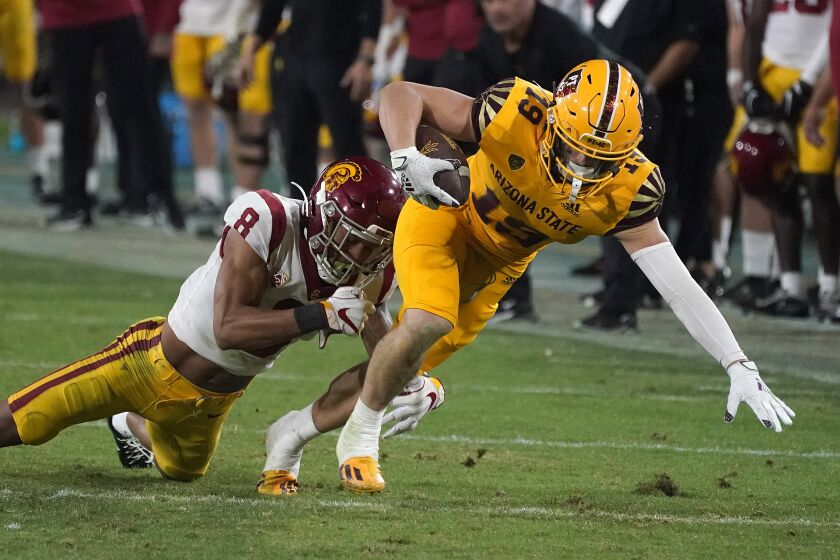 Arizona State receiver Ricky Pearsall (19) fights for extra yardage against Southern California cornerback Chris Steele (8) during the second half of an NCAA college football game Saturday, Nov. 6, 2021, in Tempe, Ariz. (AP Photo/Darryl Webb)