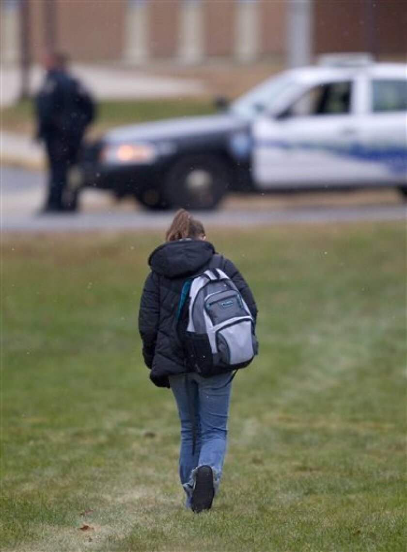 A student at Marinette High School arrives for class Wednesday morning Dec. 1, 2010 in Marinette, Wis. School was canceled on Tuesday after 15-year-old student Sam Hengel held 23 students and one teacher hostage at the school on Monday. Hengel died Tuesday morning of a self inflicted gunshot wound. (AP Photo/Mike Roemer)