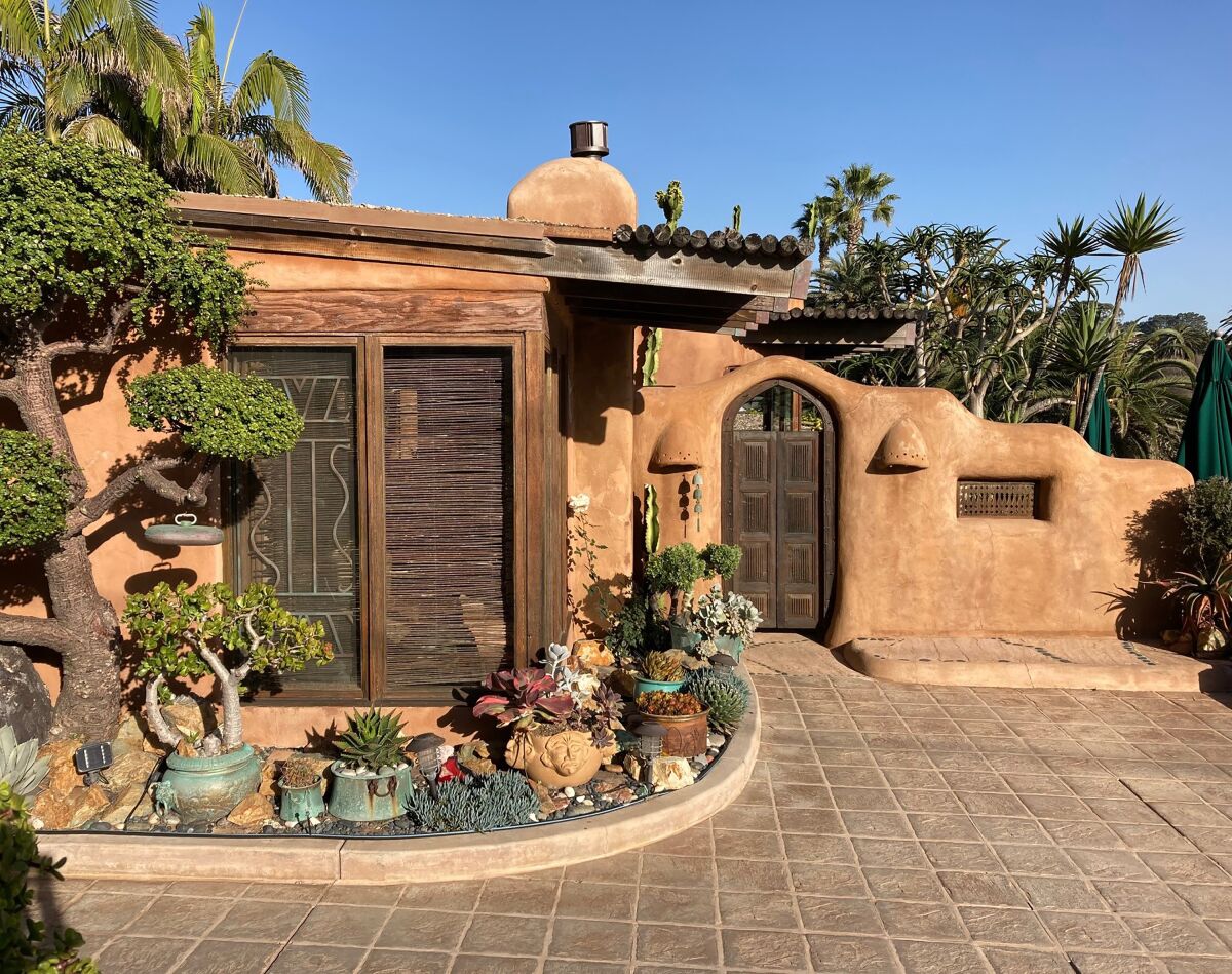 A beach-area home contains three adobe casitas with an artist’s studio, and a yard overflowing with potted succulents.