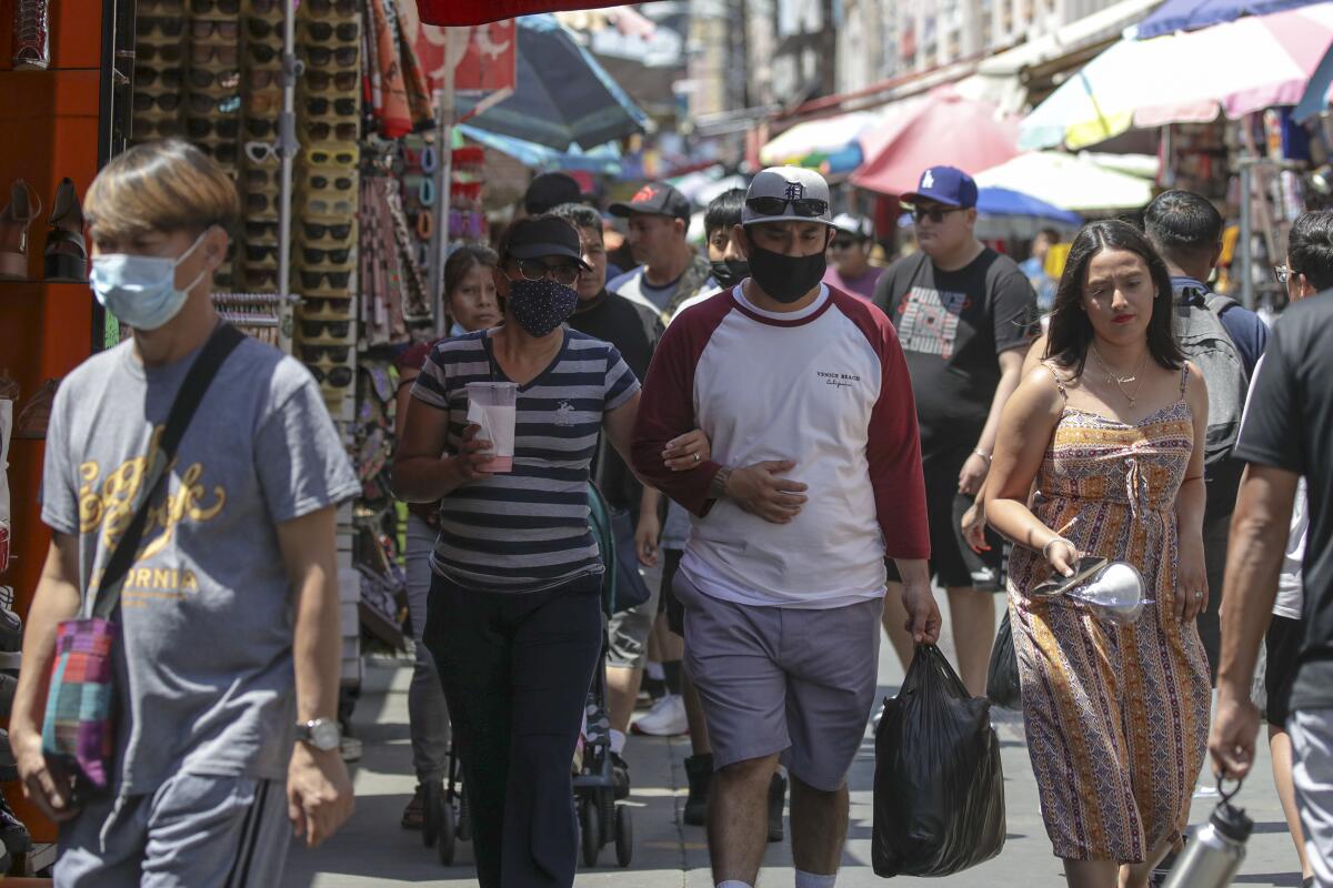 Shoppers with and without masks at Santee Alley in July 2022.