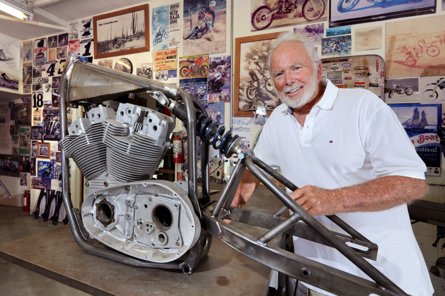 Motorcycle frame builder Jeff Cole, 76, in his home garage workshop with his Harley-Davidson XR750 frame design, a bike designed for dirt track racing featuring his mono-shock rear suspension.