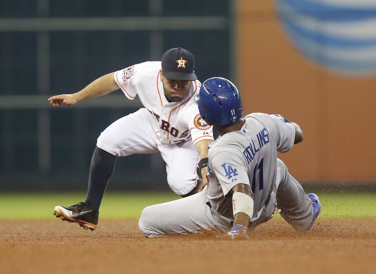 Houston's Jose Altuve tags out Jimmy Rollins during the Dodgers' 3-1 loss to the Astros on Saturday.