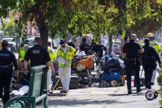 Hollywood, CA - August 15: With a heavy LAPD presence, Mayor Karen Bass' Inside Safe program employees along with the Los Angeles Sanitation Bureau clean up homeless encampments along Hollywood Blvd. on Thursday, Aug. 15, 2024 in Hollywood, CA. (Brian van der Brug / Los Angeles Times)